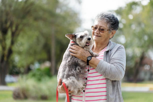 istock Affectionate senior woman embracing pet dog 1372791091