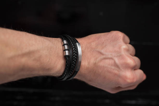 istock Black leather bracelet on a male hand 1372791101