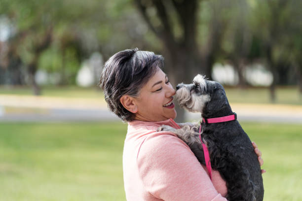 istock Middle aged woman embracing her dog 1372791108