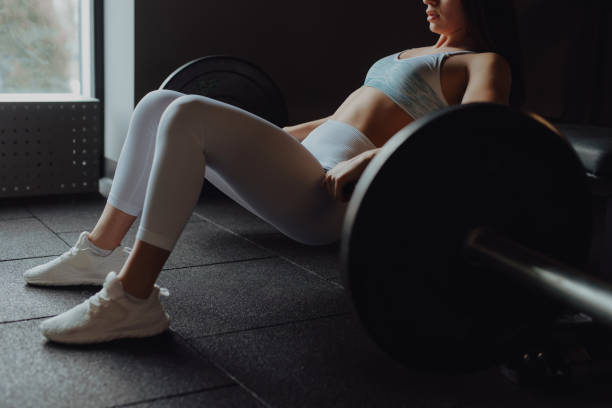 istock Woman doing buttocks bridge exercise in gym 1372792404