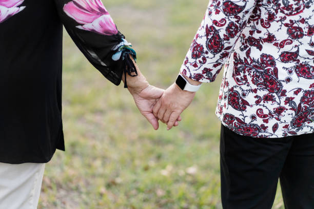 istock Senior mother and daughter holding hands 1372792601