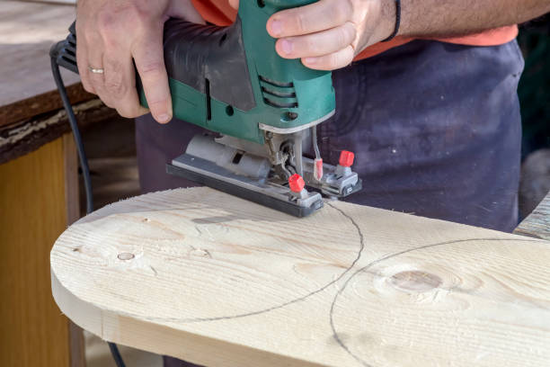 istock Men's hands with electric circular saw 1372792822