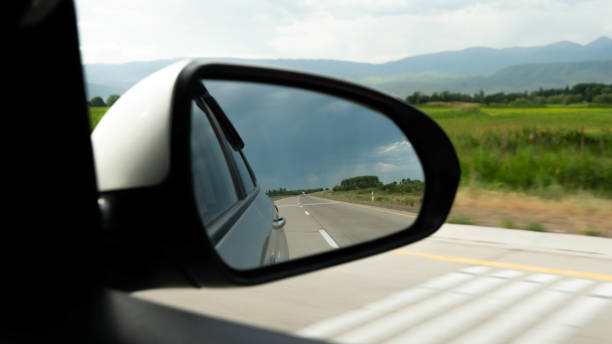 istock man driving a car. a man's hand on the steering wheel 1372794103