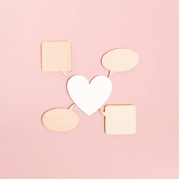 istock Centered pure white heart shaped and conversation box on pastel pink background. Virtual love texting concept. Minimal transformation need communication. Flat lay sending messages idea. 1372796205