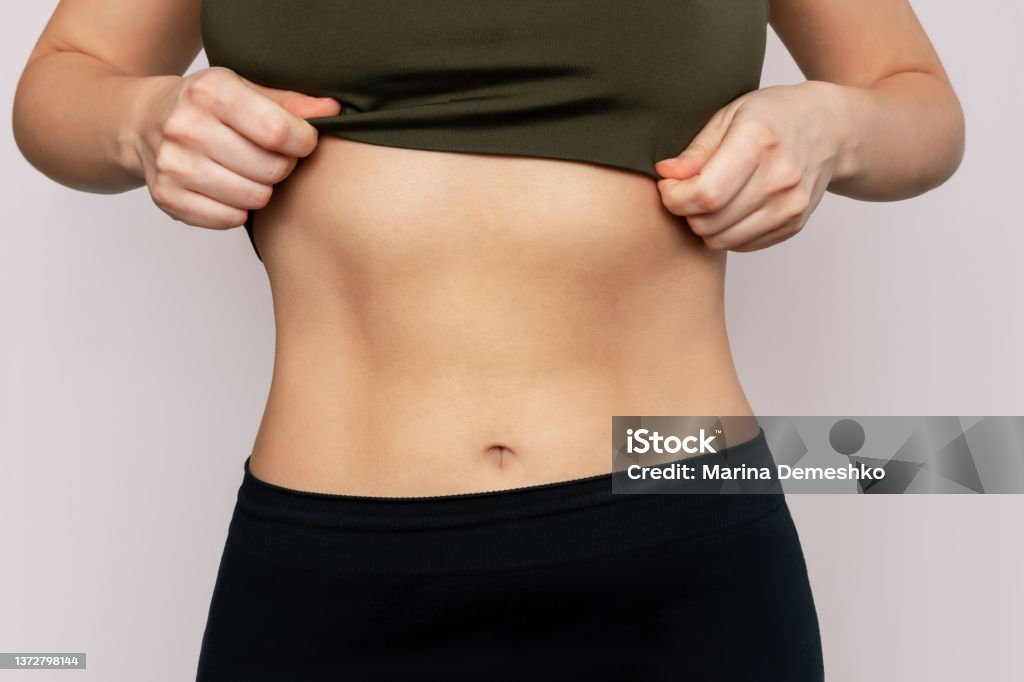 Cropped Shot Of A Young Slender Woman With Toned Stomach With Abs