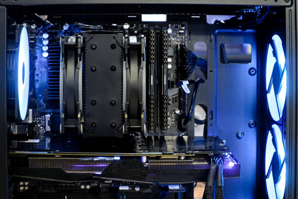 istock Close-up from inside high performance computer desktop with heatsink and fan cooling CPU and graphic card on working and LED light show status 1372798443