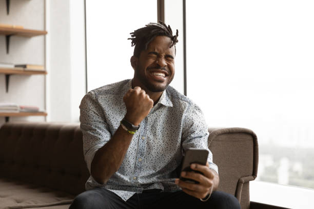 istock Overjoyed young man celebrating internet success. 1372801437