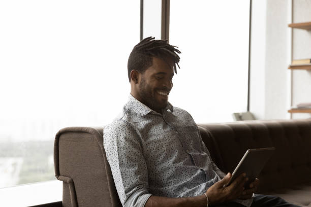 istock Happy young African American man using digital tablet. 1372801441