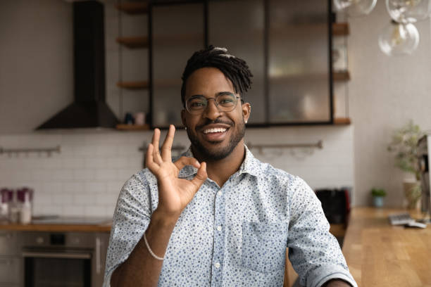 istock Happy young African ethnicity man showing okey gesture. 1372801456
