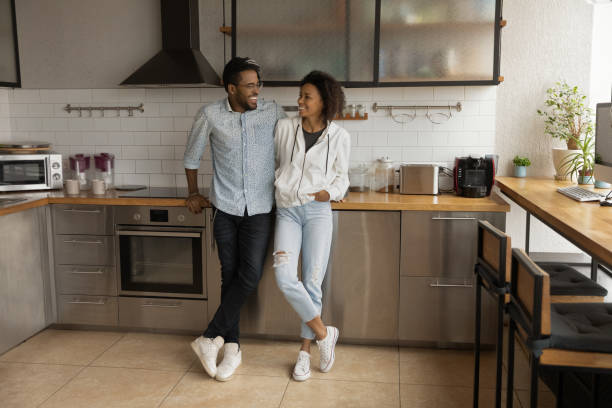 istock Young African American couple communicating in modern kitchen. 1372801468
