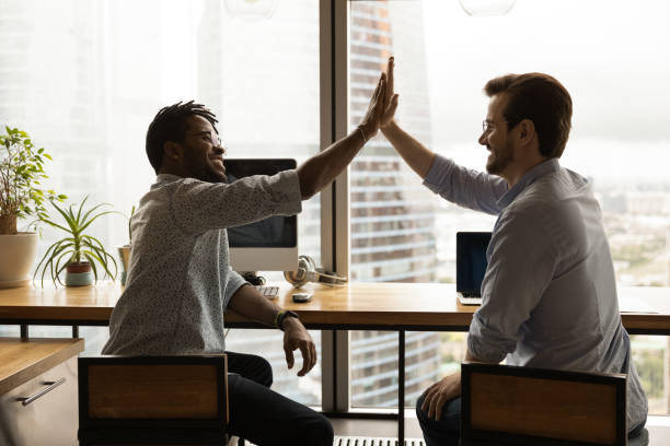istock Happy two diverse male employees giving high five. 1372801493