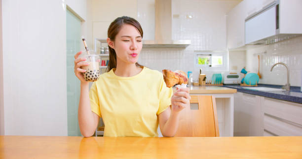 eat chicken and milk tea asian woman eat fried chicken and bubble milk tea at home happily chicken fried steak stock pictures, royalty-free photos & images