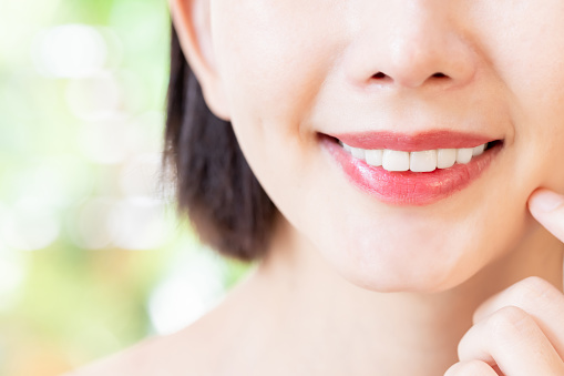 close up of asian beauty woman has good skin and health teeth