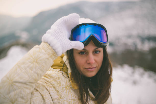 istock Young woman with snowboard in sunlight 1372807736