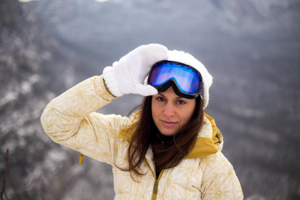 istock Young woman with snowboard in sunlight 1372807860