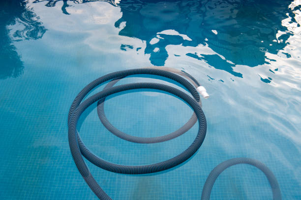 istock Cleaning the pool with a vacuum cleaner 1372809223