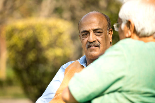 istock Two senior men discussing at park 1372809955