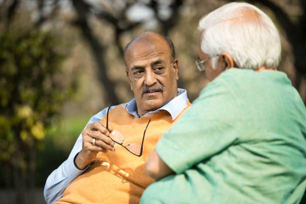 istock Two senior men discussing at park 1372810240