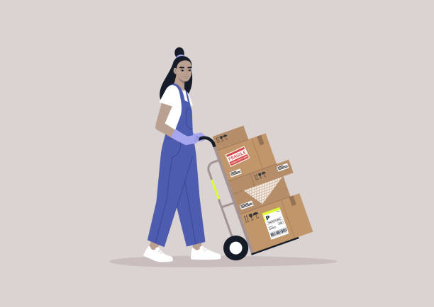 istock A young storage worker in denim overalls rolling a cart loaded with cardboard boxes, delivery service, cargo shipment 1372810351