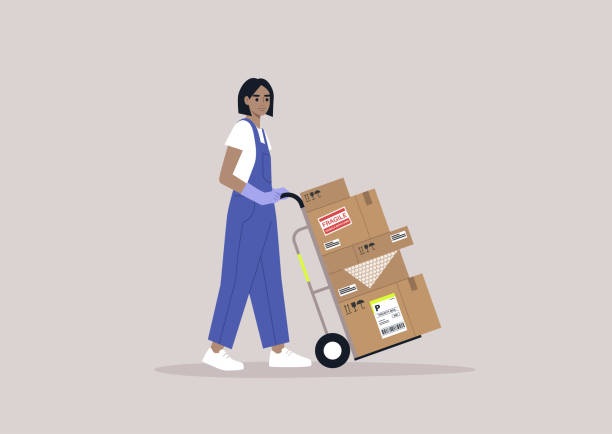 istock A young storage worker in denim overalls rolling a cart loaded with cardboard boxes, delivery service, cargo shipment 1372810352