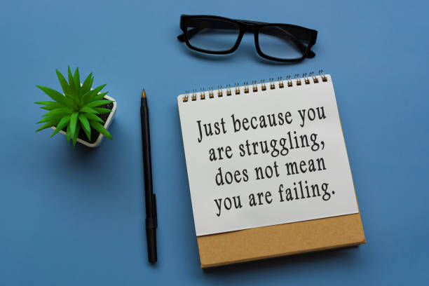 istock Motivational quote on notepad with potted plant, glasses and a pen 1372810941