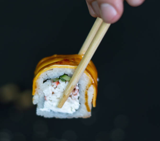 istock Sushi roll with cream cheese and fried salmon on dark background 1372811881
