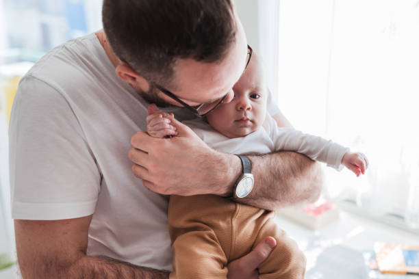 istock Displeased baby boy in his father's hands 1372814310