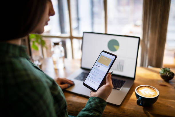 istock Woman managing digital wallet and having coffee. 1372814945