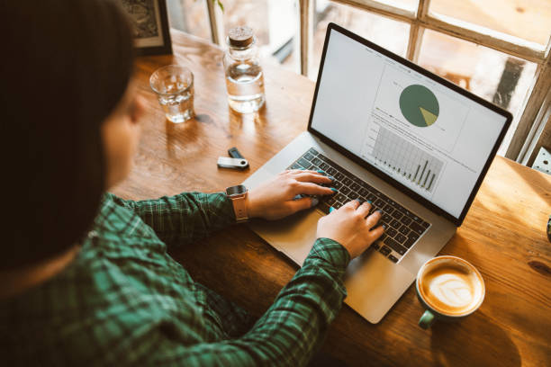 istock Woman working on laptop and having coffee. 1372814947