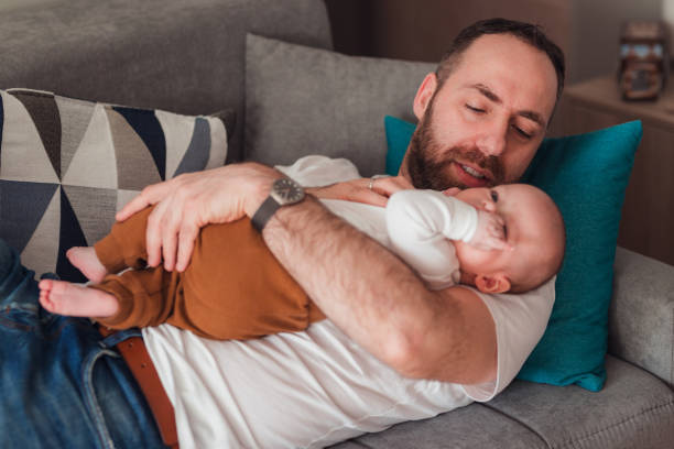 istock Tired father lying down with his baby boy 1372815563