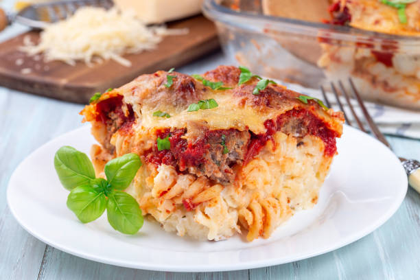 istock Mac and cheese with meatballs, mozzarella, tomato sauce and basil, on white plate, horizontal 1372818377