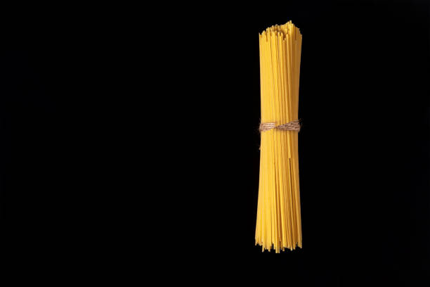 Pasta, spaghetti on a black background top view,copy space.