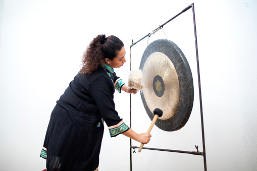 Woman giving bowl and gong therapy