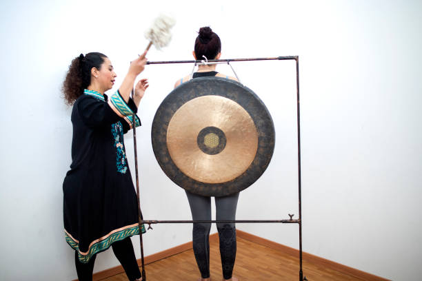 istock Woman giving bowl and gong therapy 1372820557
