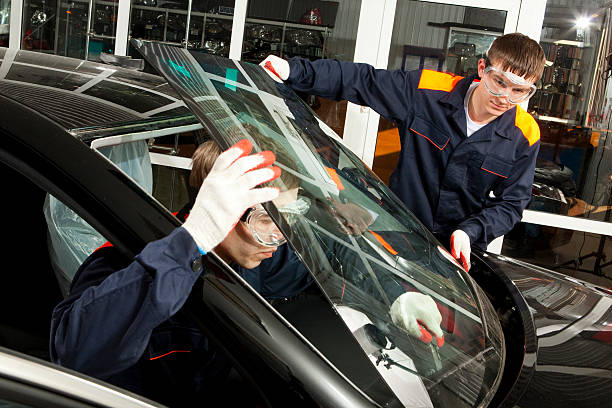Two Real Mechanics working  in Auto Repair Shop.