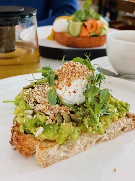 Poached eggs with avocado and bread stock photo