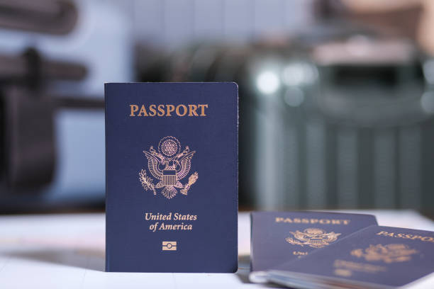 Close-up view of USA passports with luggage defocused in background. Concepts.