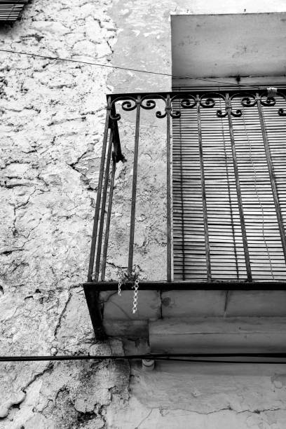 istock Old house facade with rusty balcony and blind 1372830222
