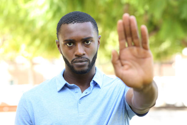 istock Black man gesturing stop sign in a park 1372831790