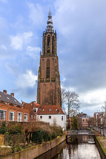 Narrow street and Oude Kerk tower in old beautiful city Delft, Netherlands