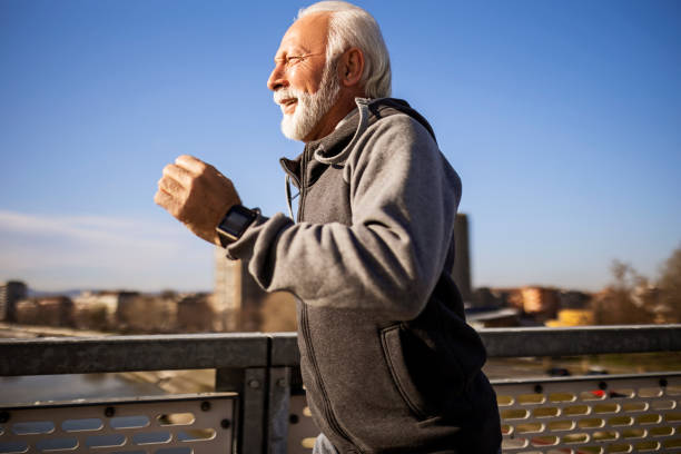 istock Smiling senior jogging in the city 1372835981