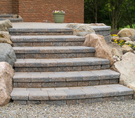 Details of stone steps leading from a patio.