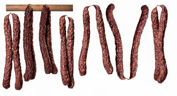 Photo of Dry smoked sausage on isolated background.