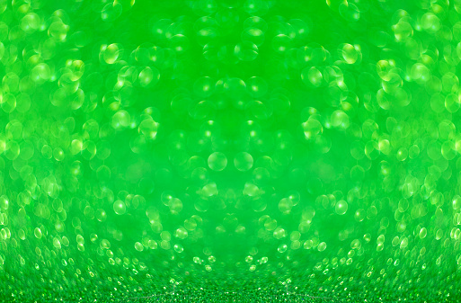 St. Patrick's Day. Light green lights. Bokeh in the shape of a clover. Blurry, fuzzy, abstract background for St. Patrick's Day. Shamrock.