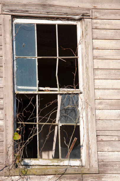 istock Wooden house with window panes broken 1372854319