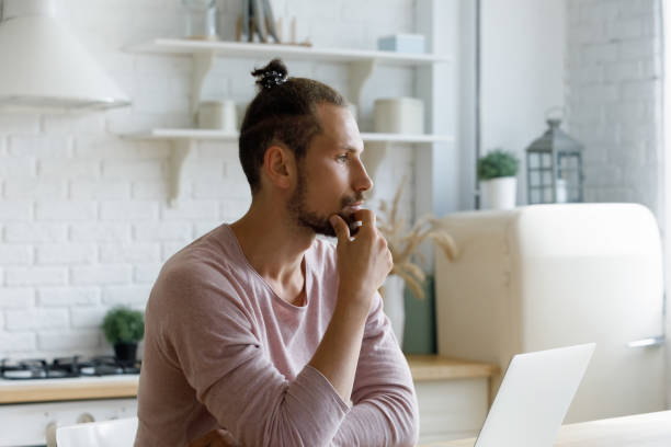 istock Pensive young male entrepreneur working on computer. 1372859456