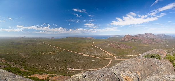 Panorama of outback Australia and deserted roads overlooking spectacular coastline from inside cave at Frenchman Peak near Esperance Bay in Western Australia.