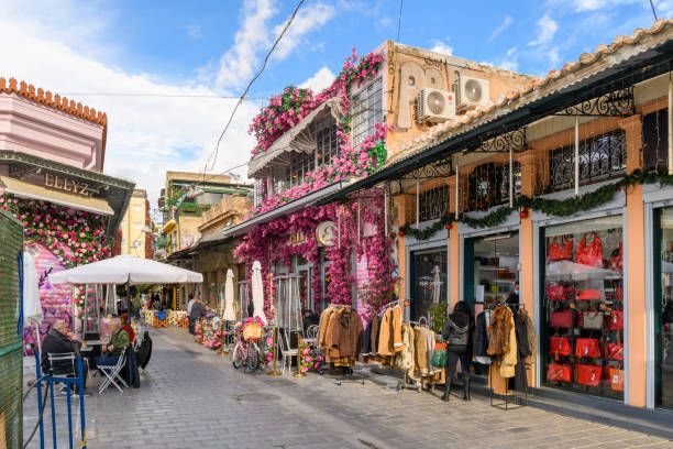 A colorful Ellyz cafe covered with pink and purple flowers, cafes and shops in the Monastiraki flea market district of Athens, Greece. A colorful Ellyz cafe covered with pink and purple flowers, cafes and shops in the Monastiraki flea market district of Athens, Greece. plaka athens stock pictures, royalty-free photos & images