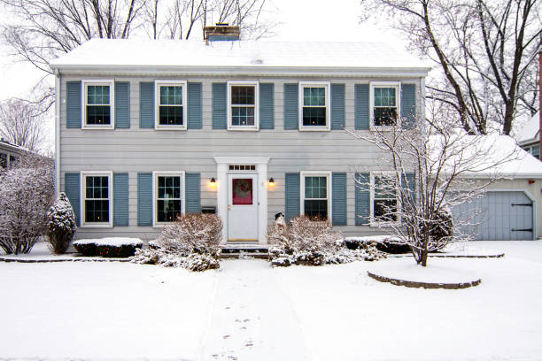 Saltbox Colonial House in Winter House at Christmas time with candles in windows and wreath on door garden lights candle stock pictures, royalty-free photos & images