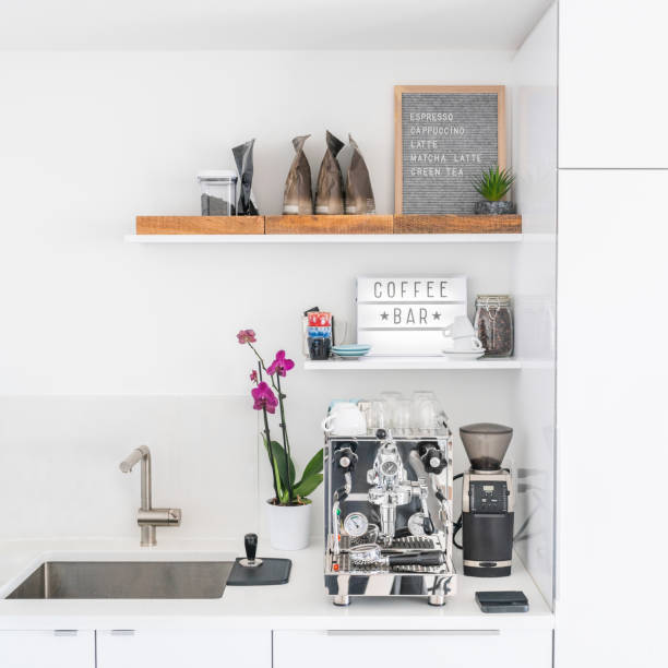 istock Luxury modern white kitchen with professional barista espresso machine on quartz countertop. Square crop of interior design background 1372873117